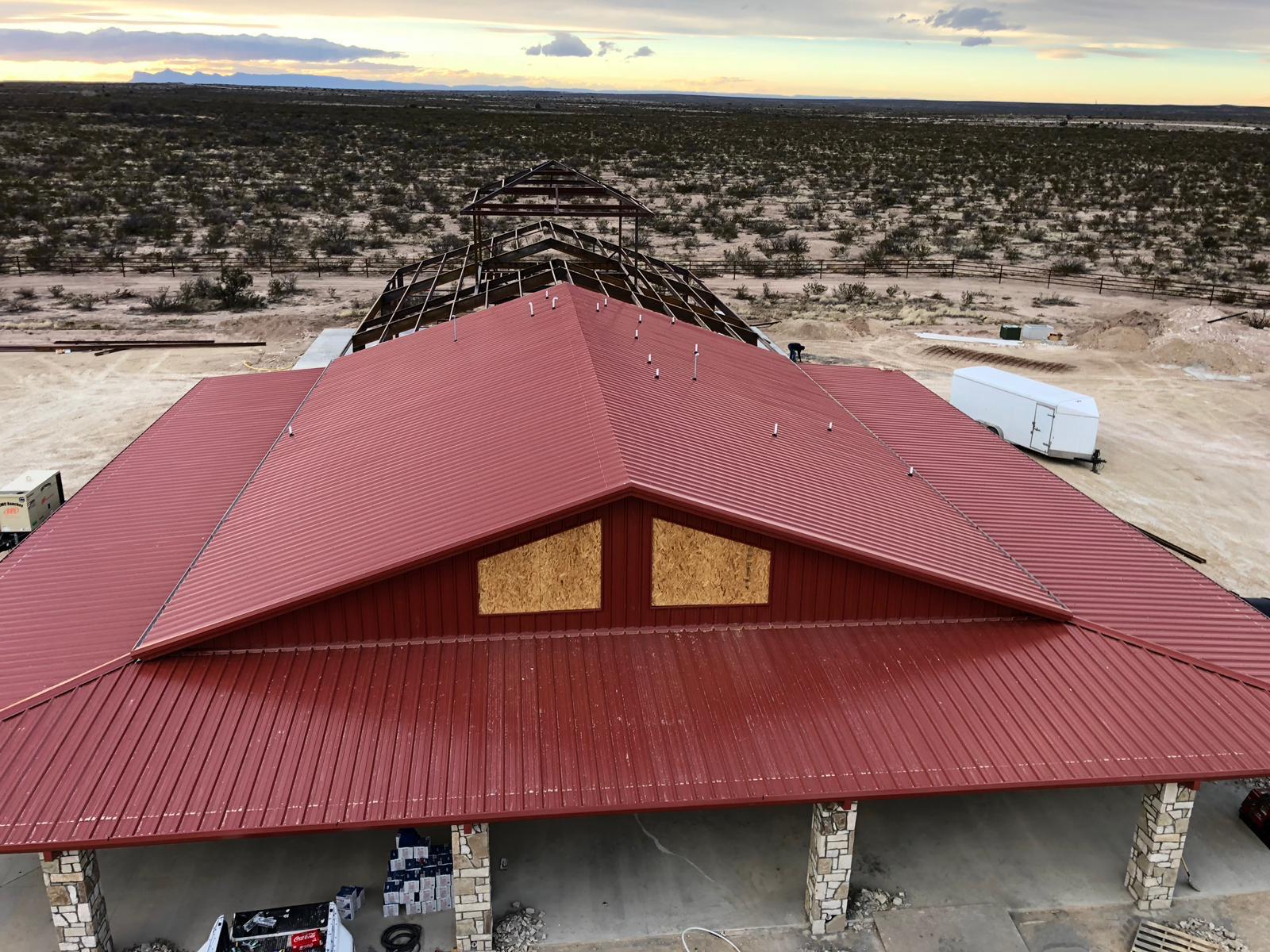 Aerial view of the finished red metal roof and gable end on a JFW Builders metal building